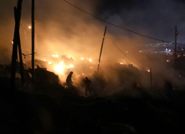 Firer fighters extinguishing the fire at Dakota Informal Settlement in Isipingo.