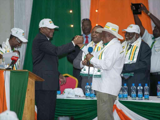 President Uhuru Kenyatta with Democratic Party leader Joseph Munyao when his re-election bid was endorsed at the party's headquarters, May 19, 2017. /COURTESY