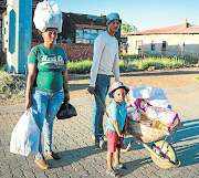 Johannes Mokgele, his wife Molebogeng and their daughter Lebogang, of Bochabela township in Bloemfontein, stock up on groceries before the lockdown came into effect on Friday. 