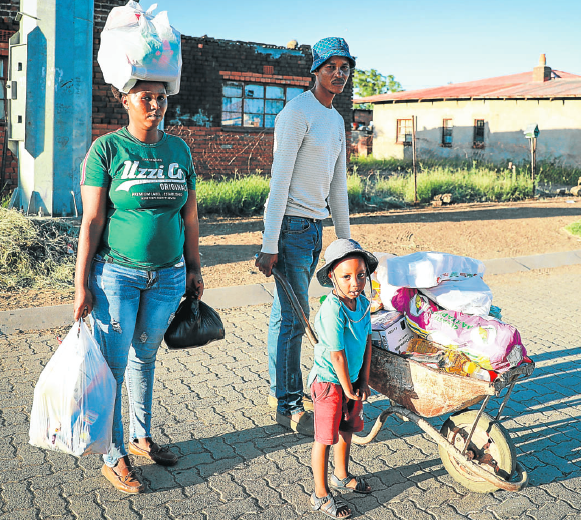 Johannes Mokgele, his wife Molebogeng and their daughter Lebogang, of Bochabela township in Bloemfontein, stock up on groceries before the lockdown came into effect on Friday.