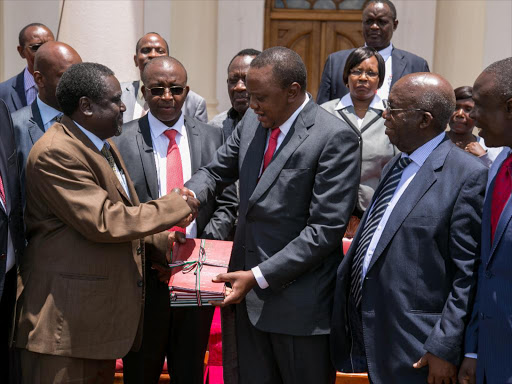 President Uhuru Kenyatta receives the Miraa Task Force report from its chairman Geoffrey Nchooro M'mwenda at State House, Nairobi.Photo PSCU