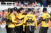 Nono Pongolo of the Jozi Stars celebrates with teammate Rassie van der Dussen (c) after catching Farhaan Behardien of Cape Town Blitz during the 2018 Mzansi Super League T20 Finals cricket match between Cape Town Blitz and Jozi Stars at Newlands, CapeTown on 16 December 2018.