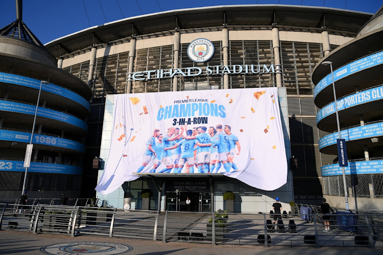 A 'Premier League Champions' banner is unfurled outside Etihad Stadium after Manchester City were confirmed as 2022-23 Premier League champions after Nottingham Forest beat Arsenal on May 20 2023.