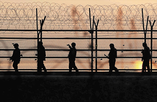 South Korean soldiers patrol the border fence with the North. Pyongyang has threatened to obliterate the South and nuke the US mainland