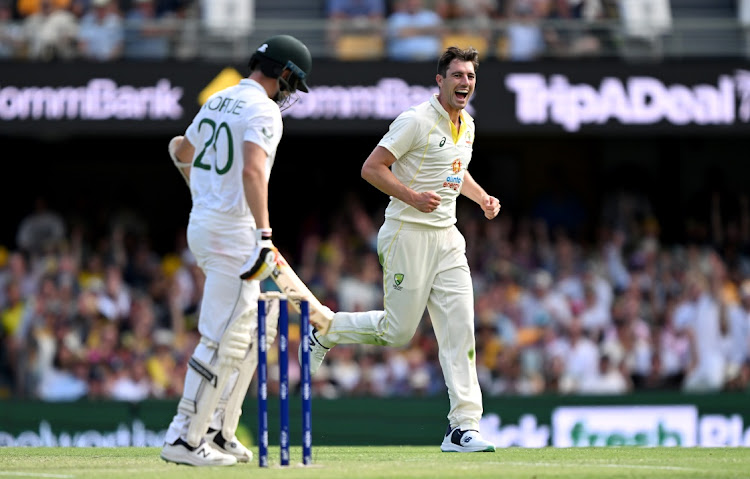 Pat Cummins of Australia celebrates taking the wicket of Anrich Nortje of South Africa on day 2 of the first Test at The Gabba in Brisbane on December 18 2022 .