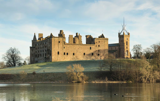 Linlithgow Palace and St. Michael's Parish Church at Linlithgow Loch, Scotland. 