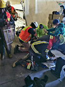 Paramedics and firefighters worked to save the injured Durban man on Tuesday.