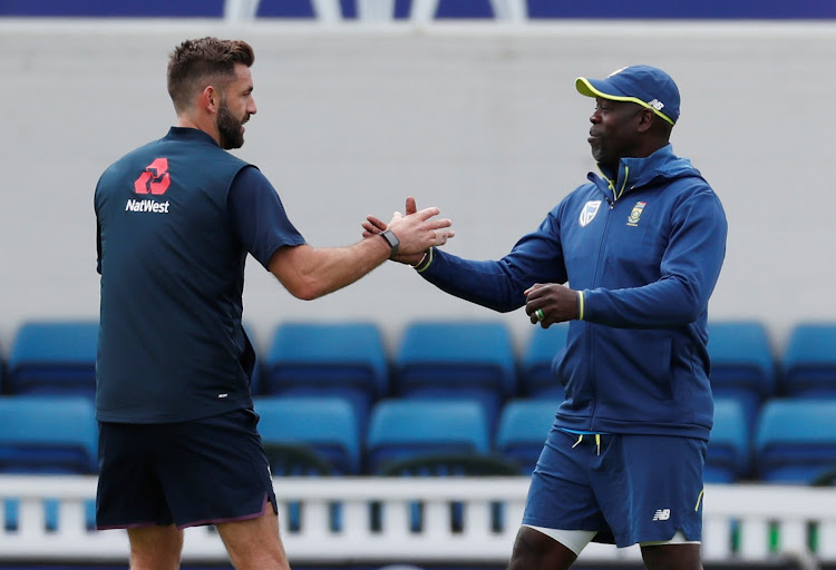 England's Liam Plunkett shakes hands with South Africa head coach Ottis Gibson during nets session at the Oval in London on May 29 2019.