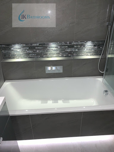 Large grey 600x600 porcelain wall and floor tiles. 3 way Bath filler control valve, hang held and rain fall shower. LED lighting 