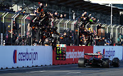 Race winner Sergio Perez passes his team celebrating on the pitwall during the F1 Grand Prix of Azerbaijan at Baku City Circuit on June 06, 2021 in Baku, Azerbaijan.