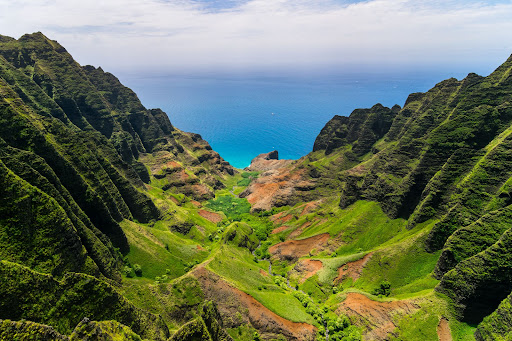 Aerial landscape view of cliffs and green valley, Kauai