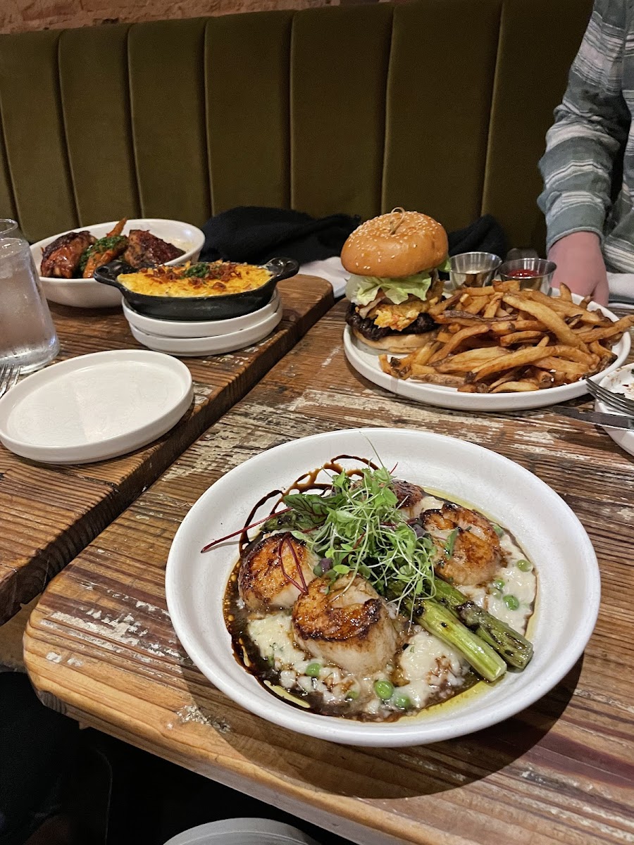 Note, my meal was the scallops. The burger bun and fries were my son’s non-gf meal, though gf burger and bun available. Catty corner plate of check was another gf option.