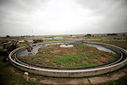 A land mover clears debris from a blocked section at the Sebokeng water treatment works.