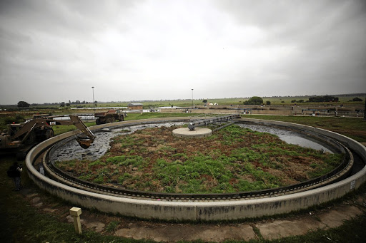 A land mover clears debris from a blocked section at the Sebokeng water treatment works.