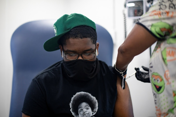 Deonjay Sailor, 15, receives his first dose of the coronavirus disease (Covid-19) vaccine at a mobile pop-up vaccination clinic hosted by the Detroit Health Department with the Detroit Public Schools Community District at East English Village Preparatory Academy in Detroit, Michigan, US, July 21, 2021.