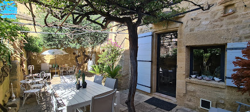 Shaded patio with table and chairs in this luxury house for sale in Remoulins ($683,804 - 260 m²)