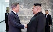 South Korean President Moon Jae-in shakes hands with North Korean leader Kim Jong Un during their summit at the truce village of Panmunjom, North Korea, in this handout picture provided by the Presidential Blue House on May 26, 2018. 