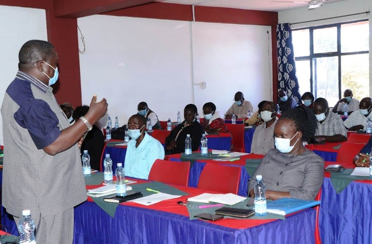 Busia County Public Service and Administration chief executive committee member speaking to the retirees.