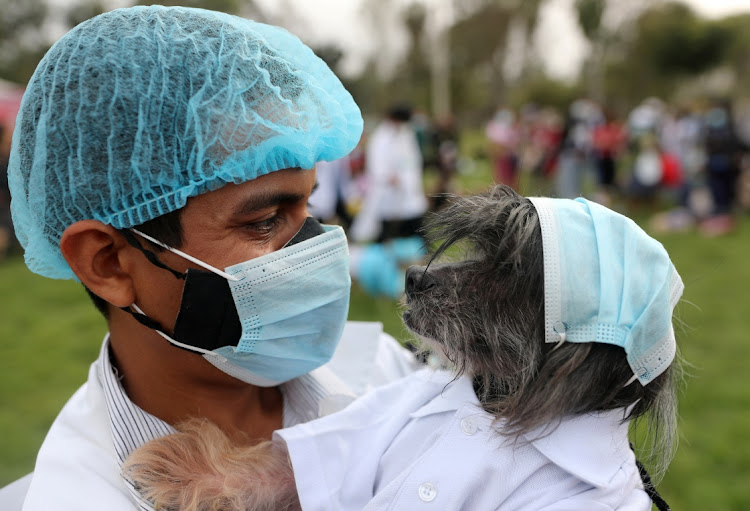 A man and dog costumed as nurses who give vaccines for the coronavirus disease (Covid-19) are pictured at a Halloween costume contest for dogs, in Lima, Peru October 21, 2021.