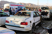 People gather at the scene of explosions during a ceremony held to mark the death of late Iranian Gen Qassem Soleimani, in Kerman, Iran, on January 3 2024. 