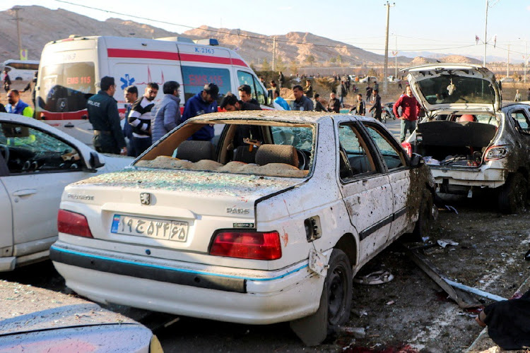 People gather at the scene of explosions during a ceremony held to mark the death of late Iranian Gen Qassem Soleimani, in Kerman, Iran, on January 3 2024.