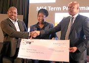 Sowetan editor-in-chief Philani Mgwaba hands over a   donation for Ngwana House to MEC Seaparo Sekoati. Tiny Koaho of Tiso Blackstar is in the middle. Image: ANTONIO MUCHAVE