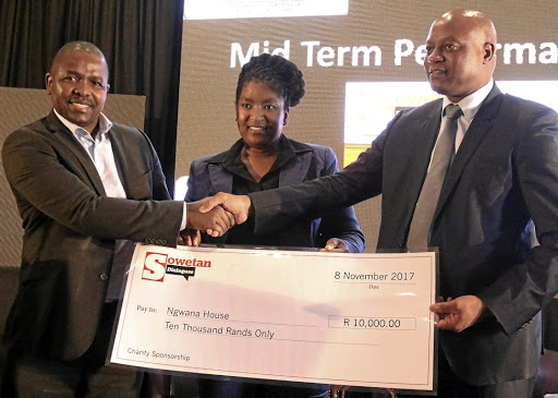 Sowetan editor-in-chief Philani Mgwaba hands over a donation for Ngwana House to MEC Seaparo Sekoati. Tiny Koaho of Tiso Blackstar is in the middle. Image: ANTONIO MUCHAVE