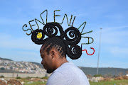 Onele Cembi uses his hair to register his protest against lockdown conditions which prevent him from operating his salon. 