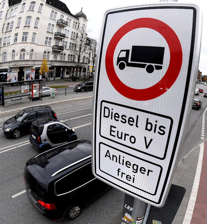 Cars pass a traffic sign banning diesel cars on a street in downtown Hamburg, Germany. Picture: SUPPLIED