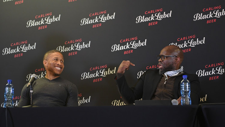 Former Kaizer Chiefs players Steve Komphela (R) and Josta Dladla share a light moment during the Carling Black Label Cup of Ages launch at FNB Stadium in Soweto on September 22 2020.