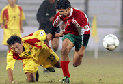 Maldives soccer team captain Mohammad Nizam (R) duels with Bhutan's Chemgho during their match in the South Asia Football Federetion (SAFF) championships at Banghabandhu National Stadium in Dhaka 11 January 2003. Maldives beat Bhutan 6-0.