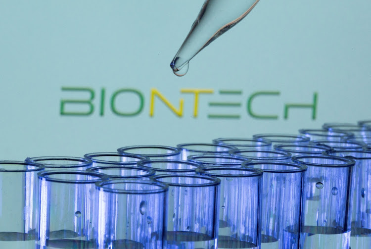 Test tubes are seen in front of a displayed Biontech logo in this illustration taken, May 21, 2021.