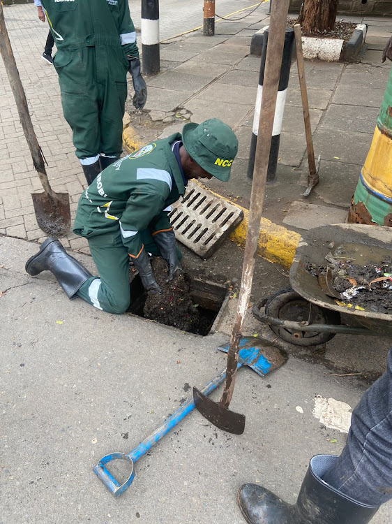 Members of the Nairobi Army unclogging drainage in Nairobi on November 6, 2023.