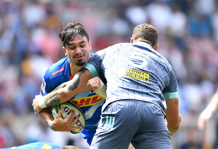 Jaco Coetzee powers through a tackle from James Blackwell of the Hurricanes during the match. Coetzee was showered with praises by his coach John Dobson after a great performance before he was forced off with a groin problem.