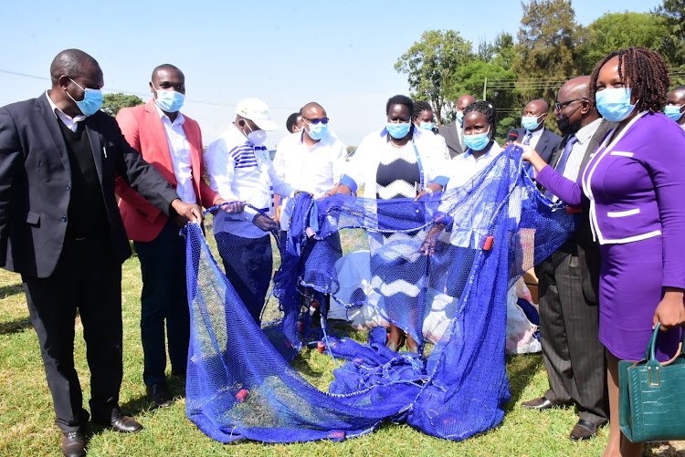 Fish farmers’ representatives receive fishing nets from the Aquaculture Business Development Programme (ABDP), county and national government officials during the Annual Aquaculture Day celebrations in Nyeri