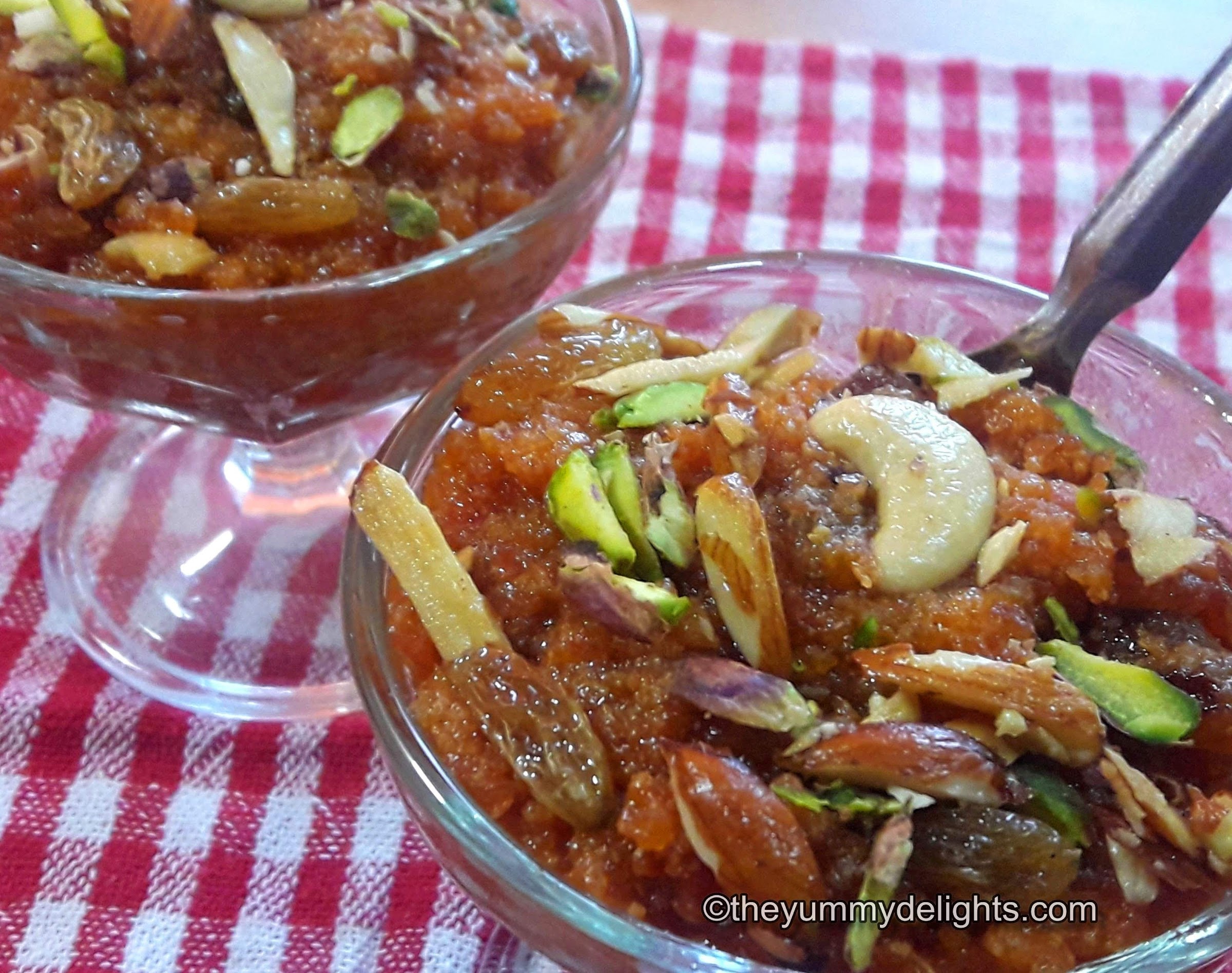 close up of Gajar ka halwa made in pressure cooker. Served in ice-cream cups with spoon.