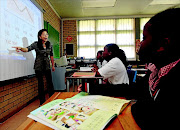 LESSON OR POISON?: Mandarin teacher Angela Liu in class with some of her pupils. The subject will be taught in public schools next year, a decision that has been criticised in many quarters. Photo:  KATHERINE  MUICK-MERE