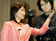 Hiroshi Ishiguro with one of his robots. File photo