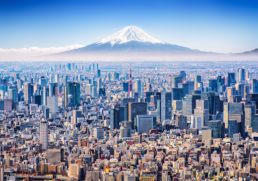 Aerial view of Mount Fuji, Tokyo Tower and modern skyscrapers in Tokyo on a sunny day