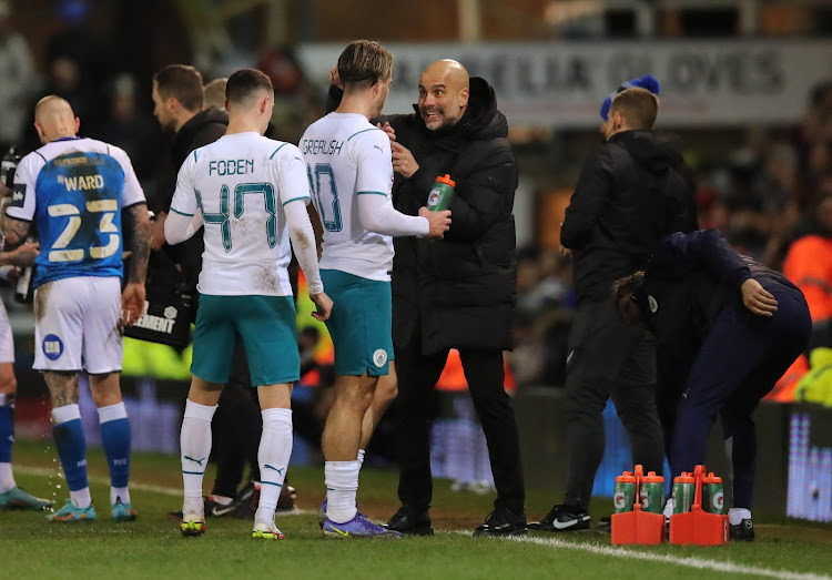 Manchester City manager Pep Guardiola with Jack Grealish and Phil Foden