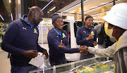 Denis Onyago, left, Lebohang Maboe and Thapelo Morena of Mamelodi Sundowns during their trophy tour at Mams Mall in Mamelodi on Tuesday.