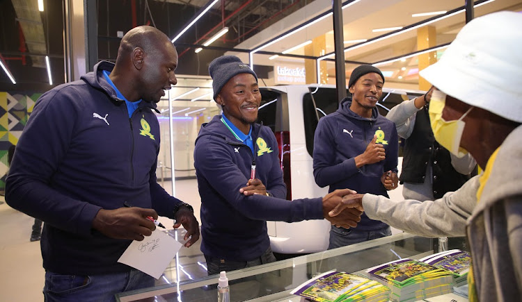 Denis Onyago, left, Lebohang Maboe and Thapelo Morena of Mamelodi Sundowns during their trophy tour at Mams Mall in Mamelodi on Tuesday.