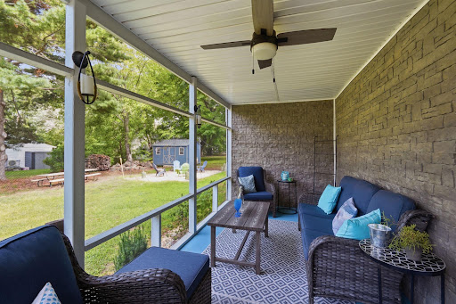 Screened porch with patio furniture and yard in this luxury property for sale in Rock Hall ($325,000)