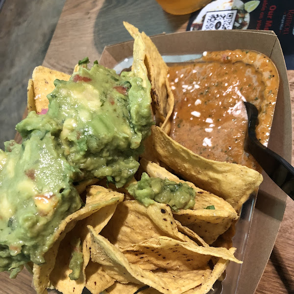 Chips loaded with pickled onions, mexican cheese, guacamole and salsa