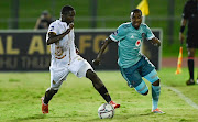 Jabulani Ncobeni of Royal AM fights for the ball with Thembinkosi Lorch of Orlando Pirates during their DStv Premiership match at Chatsworth Stadium on Friday.