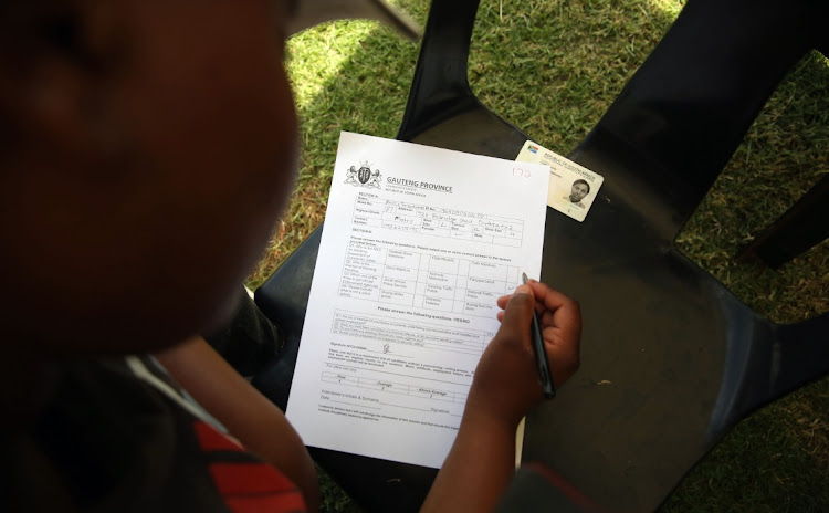 A potential recruit fills in a form before starting a fitness test at Modderbee Correctional Services.