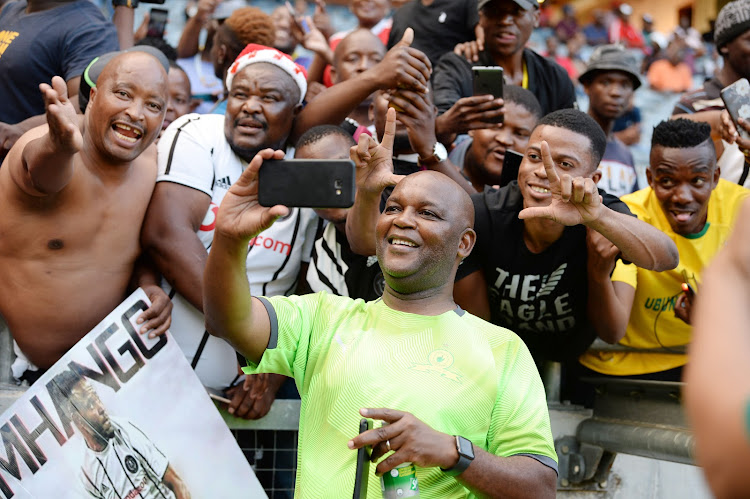 Mamelodi Sundowns coach Pitso Mosimane take selfies with Orlando Pirates supporters during the Absa Premiership match on January 15, 2020.