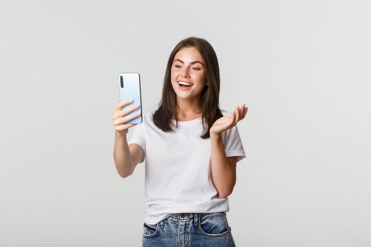 A young woman recording a video on her phone