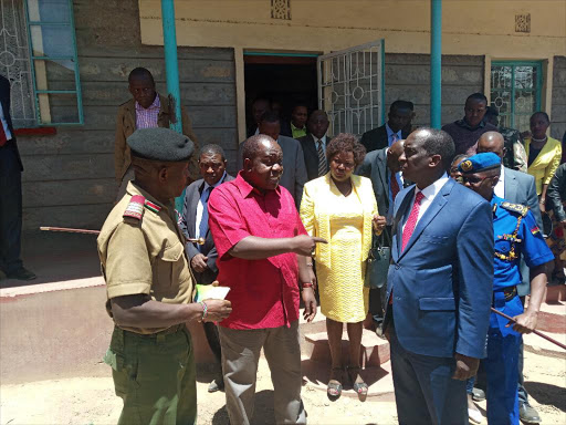 Interior Cabinet Secretary Fred Matiangi chats with Chief Administrative Secretary Patrick Ntutu and Narok County Commissioner George Natembeya in Narok county on Thursday.