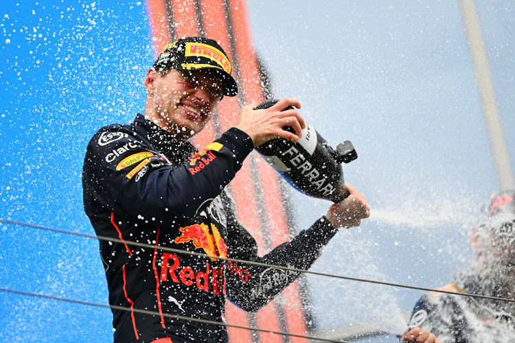 Max Verstappen celebrates on the podium after winning the F1 Grand Prix of Hungary at the Hungaroring on July 31, 2022 in Budapest, Hungary.